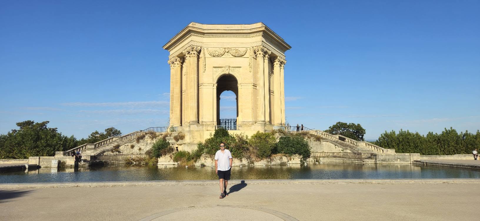 Nicholas in front of a historic monument in Montpellier