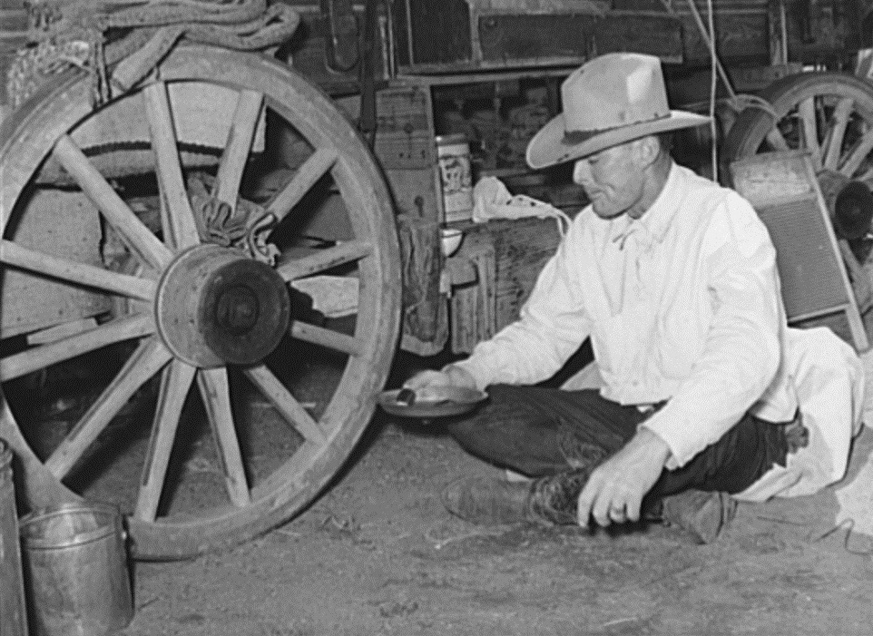 Cowboy Eating in Front of Chuck Wagon in 1939