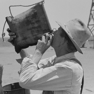 Thirsty Farmer Drinks from Canvas Bag