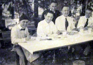 GROUP OF MEN AT PICNIC TABLE. LOCKNEY TEXAS 1905