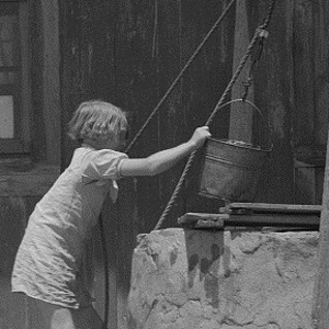 Girl Drawing Water from Well In Hall County Texas in 1939