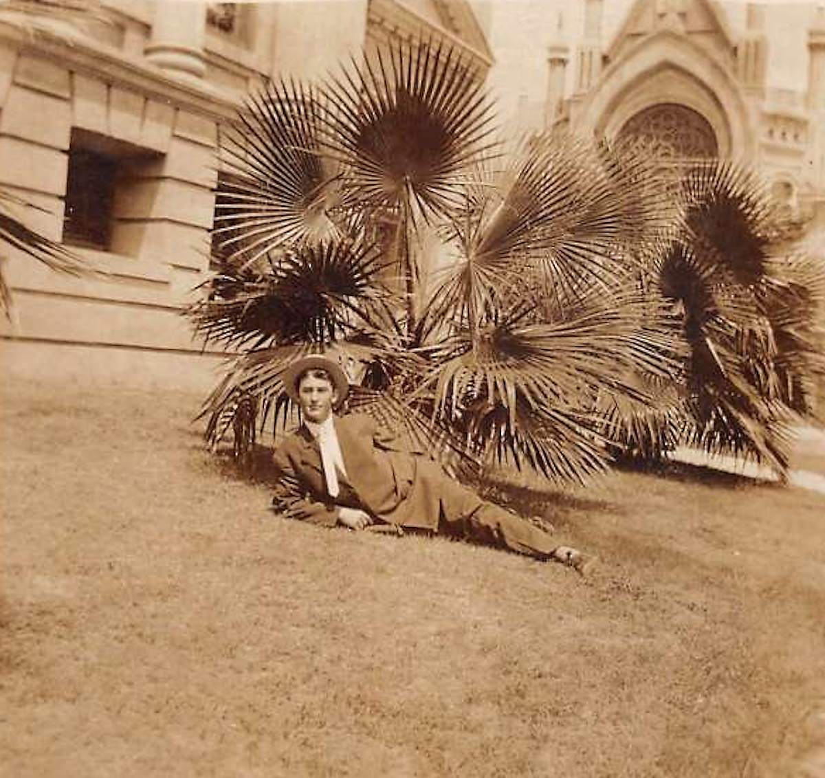 Man Reclines in Front of Fan Palms