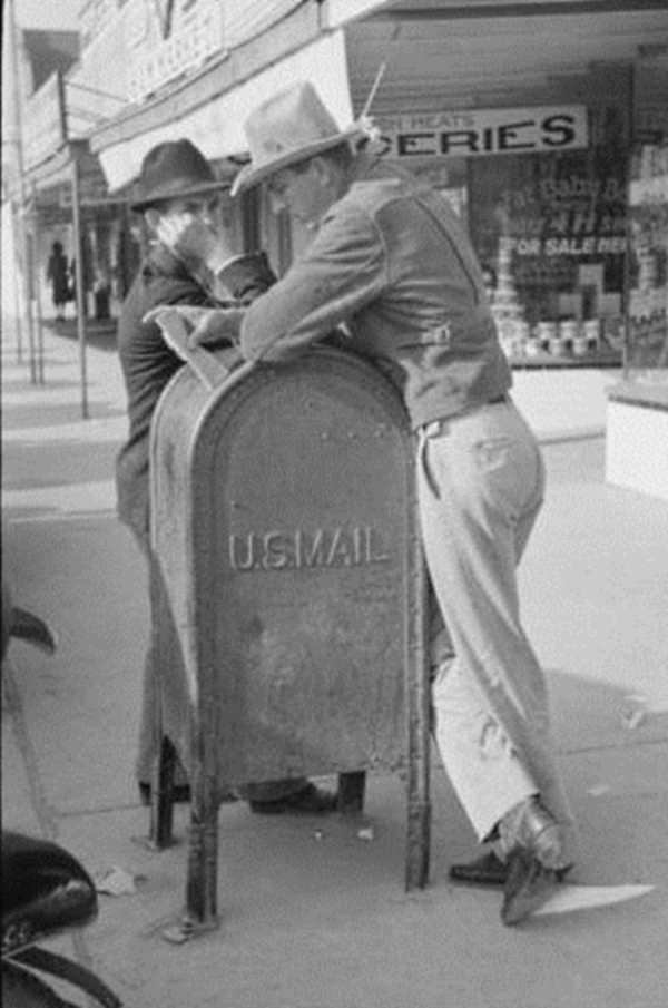 Men Leaning on Mailbox in Crystal City