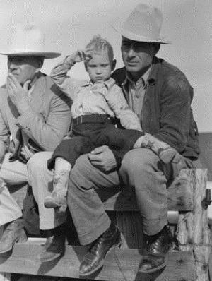 Texan and son sitting on fence at horse auction, Eldorado, Tx 1939